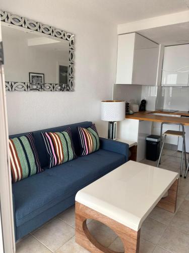 a living room with a blue couch and a table at 42 Guacimeta Club in Los Pocillos