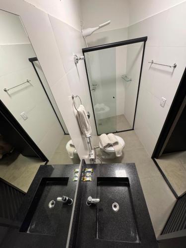 a bathroom with a sink and a toilet and a mirror at Add Hotéis Mascote in São Paulo