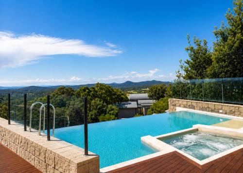 a swimming pool with a view of the mountains at One Mile Retreat - Ocean View 3 Bedroom Retreat in Anna Bay
