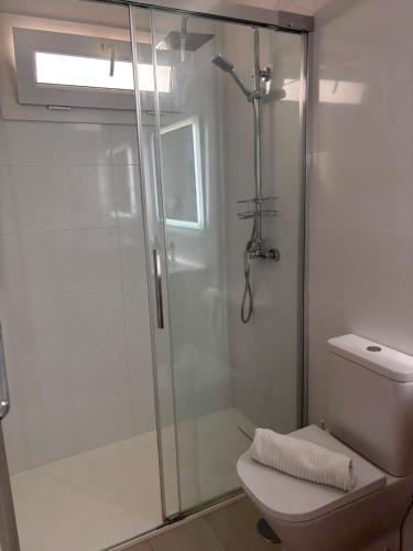 a bathroom with a glass shower with a toilet at 42 Guacimeta Club in Los Pocillos