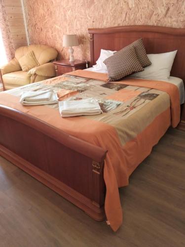 a bedroom with a large bed with clothes on it at Casa dos Cortinhais 2 in Oliveira de Frades