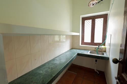a bathroom with a sink and a window at Omji Ashram - Maa Anandmayi in Vrindāvan