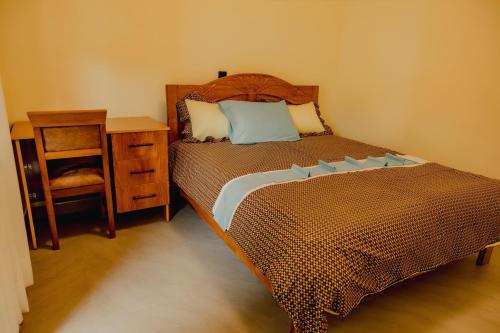 a bedroom with a bed and a desk and a chair at Sabyinyo Crest in Cyuve
