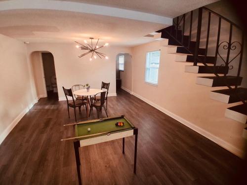 a dining room with a pool table and a staircase at House FLL airport in Fort Lauderdale