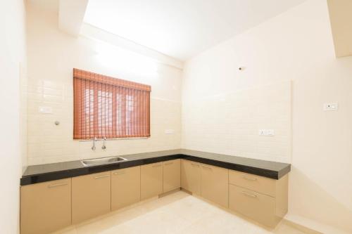 a kitchen with a sink and a window at viyan stays in Coimbatore