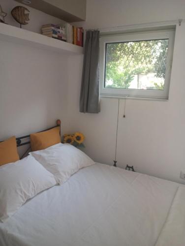 a bedroom with a bed and a window at Basic in Kalamata