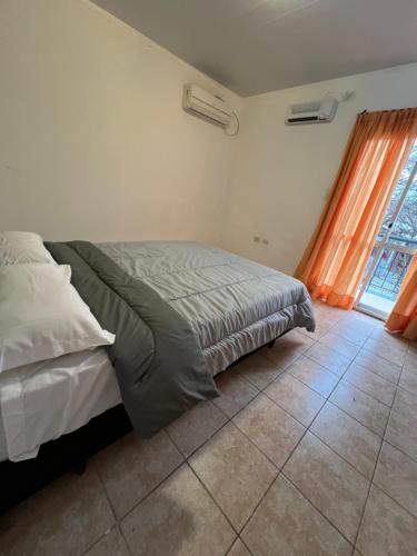 a bedroom with a bed and a window at Depto Rafaela in Rafaela