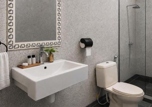a bathroom with a sink and a toilet and a mirror at Pondok Senaru Cottages in Senaru