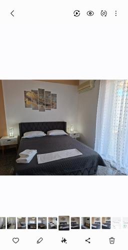 a bedroom with a bed with a black comforter at Renas home in Anavyssos
