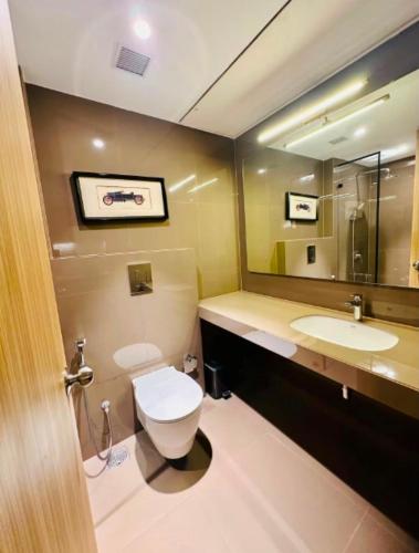a bathroom with a toilet and a sink and a mirror at Elite Haven in Raipur
