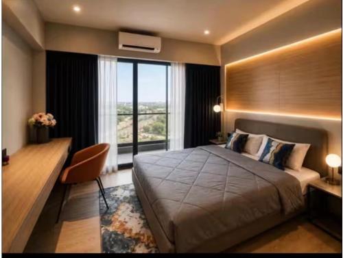 a bedroom with a bed and a desk and a window at Elite Haven in Raipur
