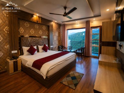 a bedroom with a large bed and a large window at Summer Hill Resort in Chail