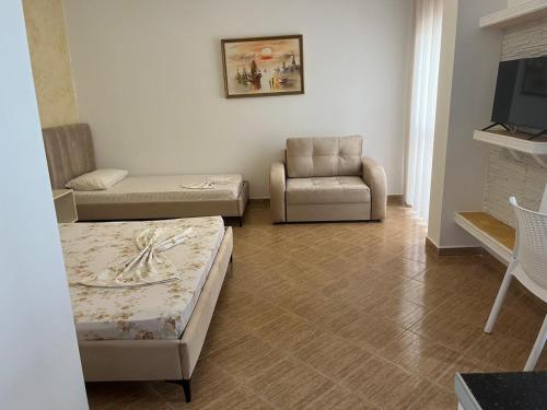 a living room with a couch and a chair at Amras house in Durrës