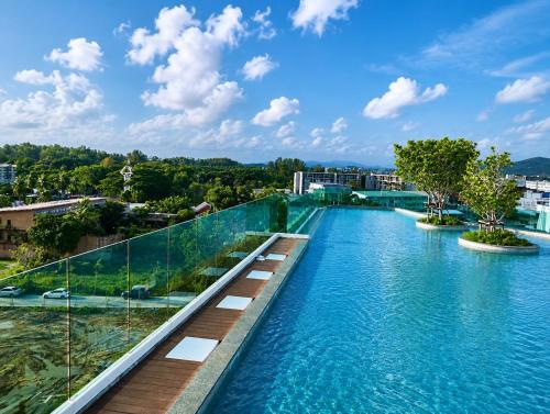 a view of a swimming pool with blue water at A417-60m2-2bedroom Serenity 66935B2I976 in Nai Yang Beach