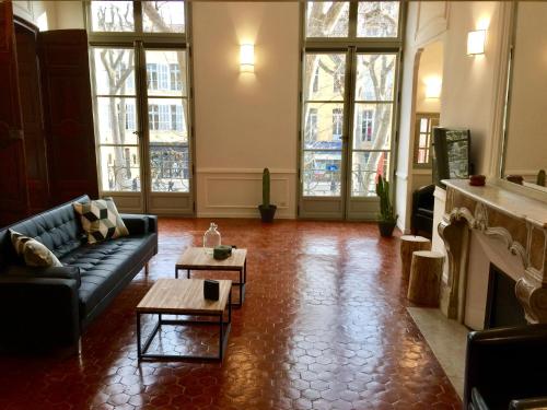 a living room with a couch and a fireplace at Les Suites du Cours & Spa in Aix-en-Provence