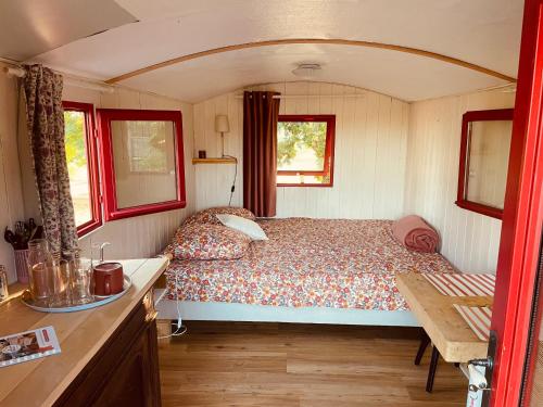 a bedroom with a bed in a small room at Domaine Casa Sana in Pillac