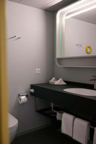 a bathroom with a sink and a mirror at Hotel Continental Park in Lucerne