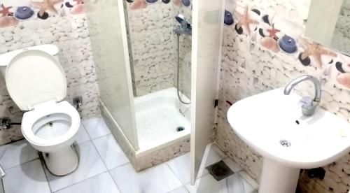 a bathroom with a toilet and a sink and a shower at New Radwan Hotel, Luxor railways in Luxor