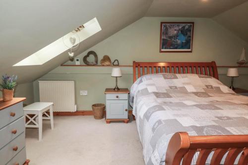 a bedroom with a bed and a attic at Skylark in Liskeard