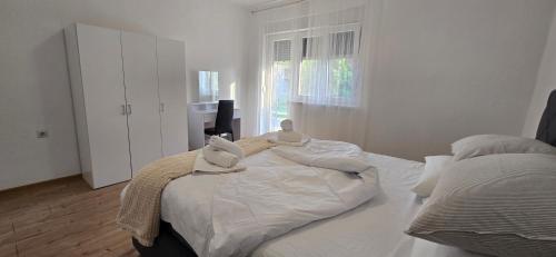 a bedroom with a large bed with pillows on it at Malo misto in Kovačić