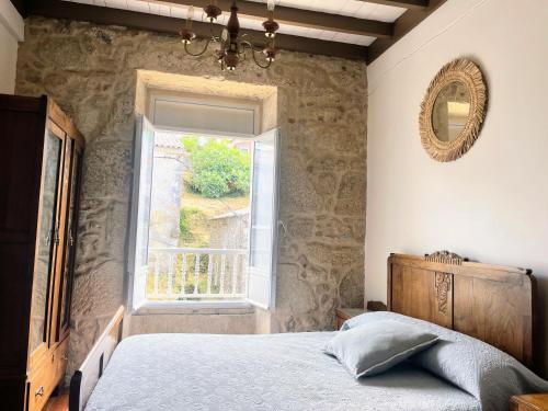 a bedroom with a bed and a window at Casa Rua in Lira