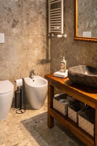 a bathroom with a sink and a tub and a toilet at Palazzo Menghina in Casaletto Spartano