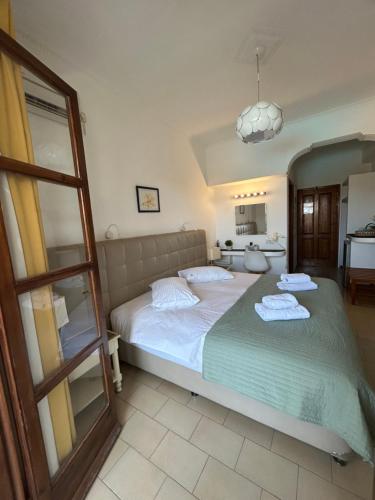 a bedroom with a bed with two towels on it at Santa Elena in Kamari