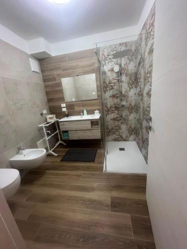 a bathroom with a shower and a toilet and a sink at Al Vicolo in Telve