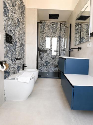 a bathroom with a tub and a toilet and a sink at 7 LAKES Aparthotel in Burolo