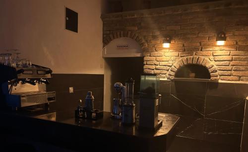 a kitchen with a counter with a brick oven at Apartmani BALKAN in Sjenica