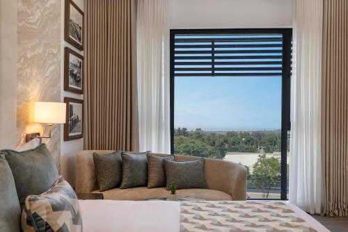 a living room with a couch and a large window at The Encore Hotel Nakuru in Nakuru