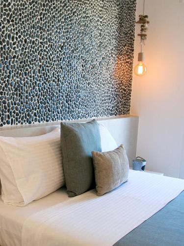 a bedroom with a bed with two pillows on it at Astropalia Luxury Studios in Astypalaia Town