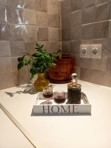 a bathroom with a plant and a sign that reads home at Basic in Kalamata