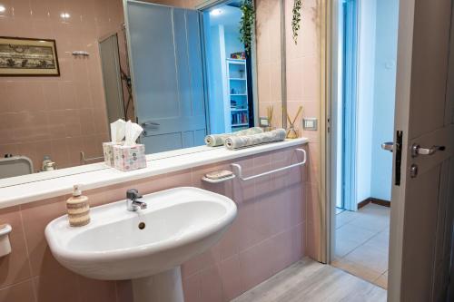 a bathroom with a sink and a mirror at Little Paradise in Taormina