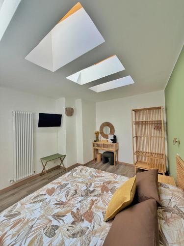 a living room with a large bed and a skylight at Amelia Apartment in Maniago