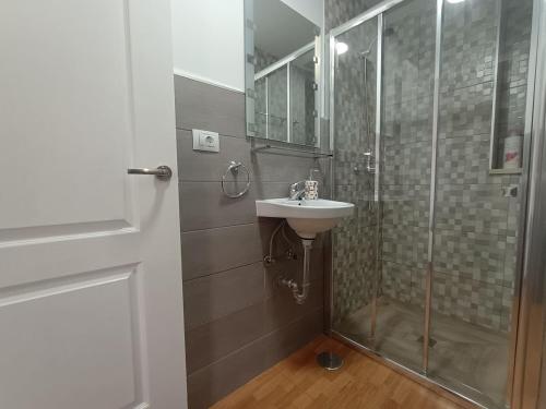 a bathroom with a shower and a sink at La Casita de Héctor in Arinaga