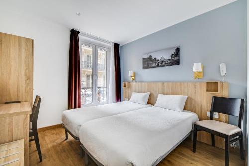a bedroom with a white bed and a chair at Altona in Paris