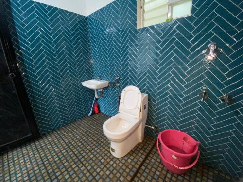a bathroom with a toilet and a sink at SOLITUDE Riverside Holiday Home in Vallikunnu