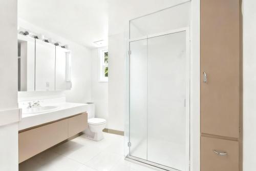a bathroom with a shower and a toilet and a sink at MOUNTAIN WILLOW GETAWAY in Jackson