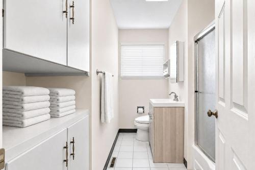 a white bathroom with a toilet and a window at MOUNTAIN WILLOW GETAWAY in Jackson