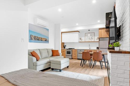 a living room and kitchen with a couch and a table at Lofts Orizon in Rimouski
