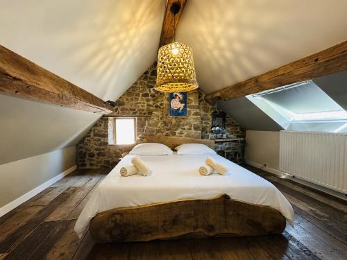 a bedroom with a large bed in a attic at Maison de gesves in Gesves