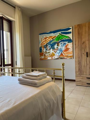 a bedroom with a bed with towels on it at B&B La Tenuta in Fermo