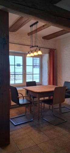 a dining room with a wooden table and chairs at Milchhäusle in Söllingen