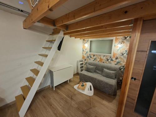 a small living room with a couch and a television at Studio Cosy proche Futuroscope in Montamisé