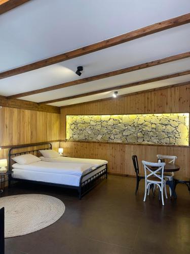 a bedroom with a bed and a table and chairs at Dilijan Tun Boutique Hotel in Dilijan
