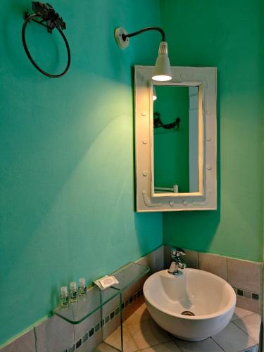 a bathroom with a sink and a mirror at KLIMA apartment in Perdika