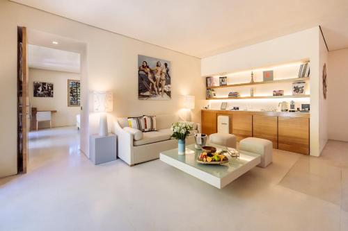 a living room with a couch and a table at MUSE Saint Tropez - Small Luxury Hotels of the World in Saint-Tropez