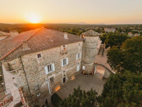 an old castle with the sunset in the background at Château De Chaussy in Ruoms
