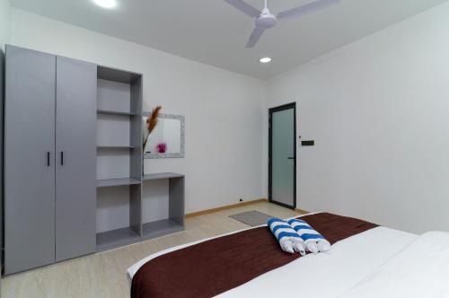 a bedroom with a bed and a closet at Nest and nook in Ukulhas